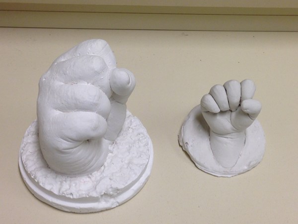 Legacy clay mold of a big hand and a small hand